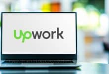 Laptop computer displaying logo of Upwork.