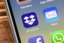 METTINGEN, GERMANY - NOVEMBER 9, 2018: Close up to dropbox app on the screen of an iPhone X with personalized background