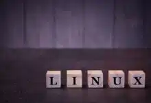The word linux on wooden cubes, on a dark background, symbols signs