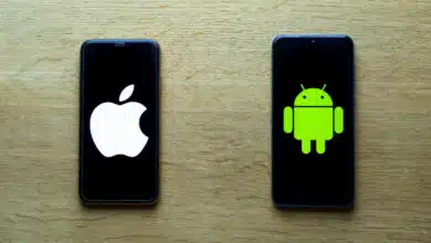 An iPhone and an Android phone on a table.