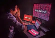 An upset person looking at multiple screens that say ransomware.
