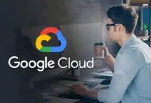 Google Cloud logo hovering over a man working at a computer while drinking from a hot beverage