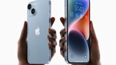 Two users holding up iPhone 14s.